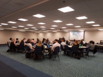 Strategic Retreat attendees listening to a speaker in a conference room